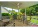This back porch features a white ceiling fan and a table and chairs for entertaining guests at 1409 Bloomingdale Ln, Mount Pleasant, SC 29466