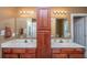 Bathroom featuring double sinks, a central cabinet, and an open doorway at 1409 Bloomingdale Ln, Mount Pleasant, SC 29466
