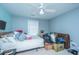 This bedroom has a ceiling fan, light blue walls and is cluttered with personal belongings and boxes at 1409 Bloomingdale Ln, Mount Pleasant, SC 29466