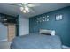 This bedroom features a ceiling fan, light wood dresser, and dark teal walls at 1409 Bloomingdale Ln, Mount Pleasant, SC 29466