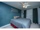Bedroom with blue walls, ceiling fan, window, and gray comforter at 1409 Bloomingdale Ln, Mount Pleasant, SC 29466