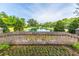 Community entrance with brick signage, colorful flowers, and a serene pond featuring a central fountain at 1409 Bloomingdale Ln, Mount Pleasant, SC 29466