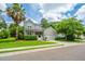 Charming two-story home with a well-maintained yard and a beautiful palm tree in the front at 1409 Bloomingdale Ln, Mount Pleasant, SC 29466