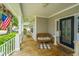 Inviting front porch with decorative columns, wicker furniture, and a welcoming American flag at 1409 Bloomingdale Ln, Mount Pleasant, SC 29466