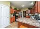 Well-lit kitchen featuring wood cabinets, black appliances, and a breakfast bar at 1409 Bloomingdale Ln, Mount Pleasant, SC 29466