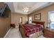 Spacious main bedroom with a tray ceiling, ceiling fan, and mounted television at 1409 Bloomingdale Ln, Mount Pleasant, SC 29466