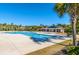 Community pool with blue water, shaded picnic area, and palm trees on a sunny day at 1409 Bloomingdale Ln, Mount Pleasant, SC 29466