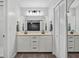 Neutral toned bathroom featuring double sinks, a large mirror, and ample lighting at 141 Tall Pines Rd, Ladson, SC 29456