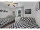 A spacious bedroom with playful checkered decor, a ceiling fan, and ample natural light at 141 Tall Pines Rd, Ladson, SC 29456