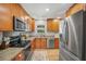 Well-lit kitchen featuring stainless steel appliances, granite countertops, and wood cabinets at 141 Tall Pines Rd, Ladson, SC 29456