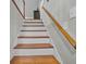 Classic staircase with wooden handrail and white risers leading to the upper floor at 141 Tall Pines Rd, Ladson, SC 29456