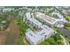 A scenic aerial view of the community with multiple buildings and lush green spaces surrounded by a body of water at 145 Pier View St # 214, Daniel Island, SC 29492