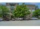 Apartment complex with mature trees, private balconies, and a well-maintained parking area at 145 Pier View St # 214, Daniel Island, SC 29492