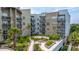 Apartment exterior featuring brick and siding, complemented by lush landscaping in the courtyard at 145 Pier View St # 214, Daniel Island, SC 29492