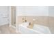 Relaxing bathroom features a soaking tub, shower, and tiled surround at 145 Pier View St # 214, Daniel Island, SC 29492
