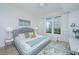 Cozy bedroom with a plush rug, large windows, and a comfortable bed at 145 Pier View St # 214, Daniel Island, SC 29492