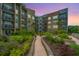 Exterior view of the building shows multiple units, balconies, landscaping, and manicured walking paths at 145 Pier View St # 214, Daniel Island, SC 29492