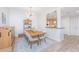 Elegant dining room featuring modern chandelier and wood table adjacent to an open kitchen area at 145 Pier View St # 214, Daniel Island, SC 29492