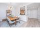 Elegant dining room with modern chandelier and wood table adjacent to an open kitchen area at 145 Pier View St # 214, Daniel Island, SC 29492