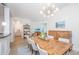 Bright dining room with modern chandelier and wood table, which opens to the living room at 145 Pier View St # 214, Daniel Island, SC 29492