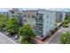 Aerial exterior view of a modern apartment building with brick accents, balconies, and a parking lot at 145 Pier View St # 214, Daniel Island, SC 29492