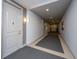 Well-lit apartment hallway with neutral paint, carpet, and door to unit 214 at 145 Pier View St # 214, Daniel Island, SC 29492