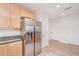 Bright kitchen with stainless steel refrigerator, granite countertops, and wood cabinets in a modern home at 145 Pier View St # 214, Daniel Island, SC 29492