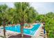 Relaxing pool area with lounge chairs, palm trees, and a separate shallow area for soaking at 145 Pier View St # 214, Daniel Island, SC 29492
