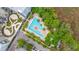 Aerial view of a large community pool surrounded by lush greenery and palm trees at 145 Pier View St # 214, Daniel Island, SC 29492