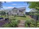 Landscaped backyard with grass, gardens, walking paths, and home exterior view at 148 Longdale Dr, Summerville, SC 29483