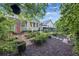 Landscaped backyard with gardens, brick walking paths, grass, and flowers at 148 Longdale Dr, Summerville, SC 29483