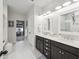 Stylish bathroom with a double vanity, modern lighting, and view into a closet at 148 Longdale Dr, Summerville, SC 29483