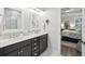 Well-lit bathroom with double vanity, modern fixtures, and a view into the bedroom at 148 Longdale Dr, Summerville, SC 29483