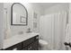 Cozy bathroom with a modern vanity, decorative mirror, and shower with curtain at 148 Longdale Dr, Summerville, SC 29483