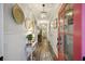 Bright hallway featuring decorative accents, a wood floor, a bold pink front door, and a view to other rooms at 148 Longdale Dr, Summerville, SC 29483