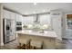 Bright kitchen with stainless steel appliances and large island with seating and white cabinets at 148 Longdale Dr, Summerville, SC 29483