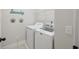 Bright laundry room with modern washer and dryer, plus convenient shelving for storage at 148 Longdale Dr, Summerville, SC 29483