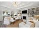 Elegant living room with built-in bookshelves, a cozy fireplace, and plush seating for entertaining at 148 Longdale Dr, Summerville, SC 29483