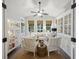 Bright sunroom with white furniture, decorative cabinets, ceiling fan, and natural light at 148 Longdale Dr, Summerville, SC 29483