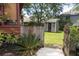 This backyard boasts a lush lawn and a storage shed complete with artistic flair and an entrance leading to the side yard at 152 Mansfield Blvd, Charleston, SC 29418