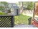 Backyard featuring a shed with star decor, a fenced perimeter, and mature trees at 152 Mansfield Blvd, Charleston, SC 29418
