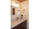 Well-lit bathroom vanity featuring a tile countertop and classic fixtures with a mirror at 152 Mansfield Blvd, Charleston, SC 29418