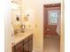 Bathroom vanity with sink and mirror, door to toilet and shower with stained glass window at 152 Mansfield Blvd, Charleston, SC 29418