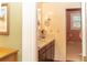 Bathroom vanity featuring a sink, a framed mirror, and an open door to a toilet and shower at 152 Mansfield Blvd, Charleston, SC 29418