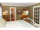 Bedroom view with a white metal bed and vintage dressers with unique stained glass door at 152 Mansfield Blvd, Charleston, SC 29418