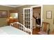 Bedroom features a bed, dresser, and stained glass doors leading to another room at 152 Mansfield Blvd, Charleston, SC 29418