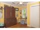 A cozy bedroom with light yellow walls, hardwood floors, and a large antique cabinet at 152 Mansfield Blvd, Charleston, SC 29418