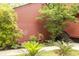 Close up of charming landscaping of red home featuring mature trees and native plants at 152 Mansfield Blvd, Charleston, SC 29418