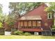 This exterior view features a bright sunroom, manicured gardens, and a stairway leading to the garden with native plants at 152 Mansfield Blvd, Charleston, SC 29418