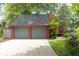 Charming exterior of red home featuring an attached two-car garage, long driveway, and landscaping at 152 Mansfield Blvd, Charleston, SC 29418